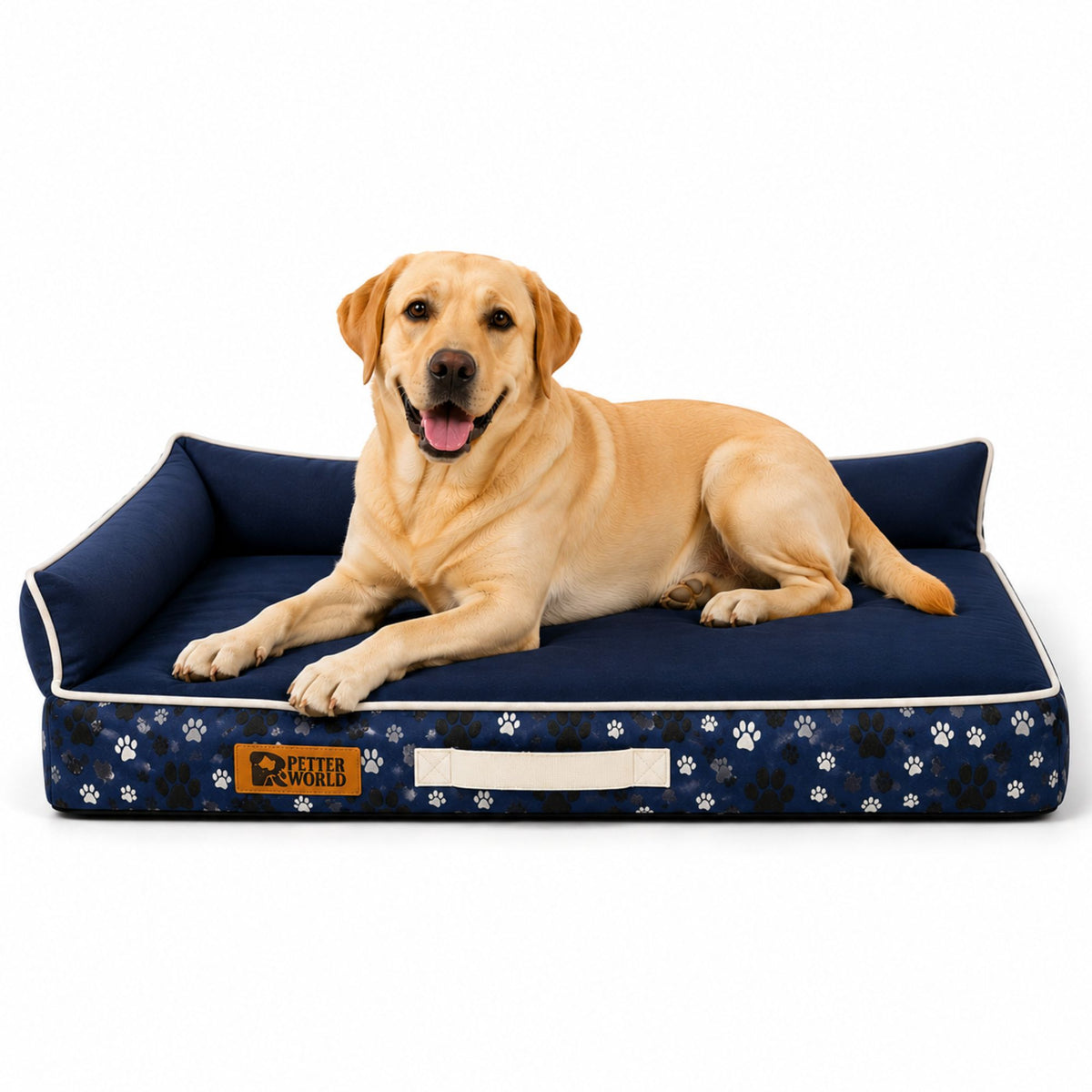 A yellow Labrador Retriever lies on a navy blue pet bed with white paw print patterns and a white handle, photographed on a clean white background.