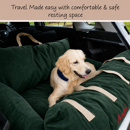 A golden retriever dog rests on an olive green car travel dog bed inside a vehicle. The bed has beige woven straps and red embroidered text reading 'Angel'.